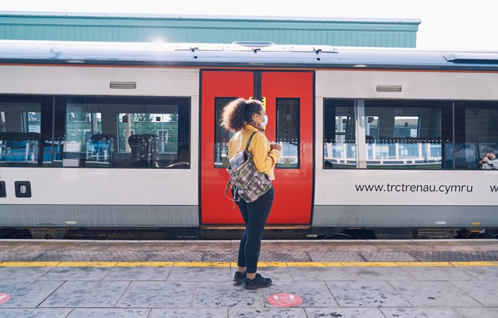 A woman waiting for a train.