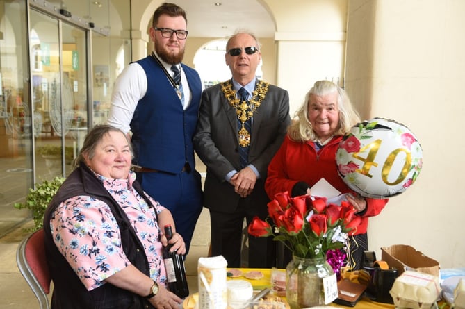 Flower lady Gwen with the Mayor of Monmouth Councillor Terry Christopher and his consort, Ross Ingram and Linda Campbell at Gwen’s flower stall under the arches at the Shire Hall