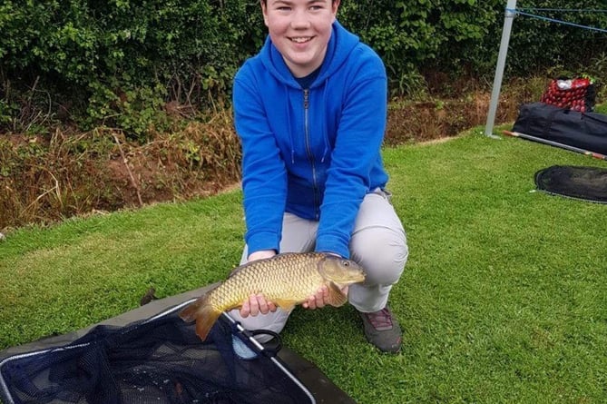 A happy angler with a common carp