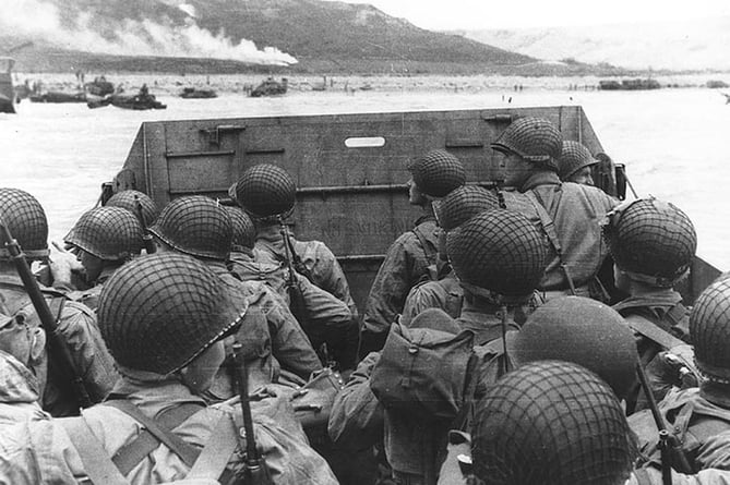 Troops in an LCVP landing craft approach Omaha Beach on D-Day, June 6, 1944.
Note the helmet netting, faint "No Smoking" sign on the LCVP's ramp, the M1903 rifles and M1 carbines carried by some of these men. ( https://creativecommons.org/licenses/by/2.0/)