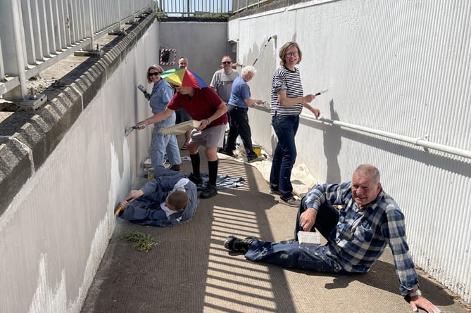 The volunteers painting the base coat on the subway walls last month