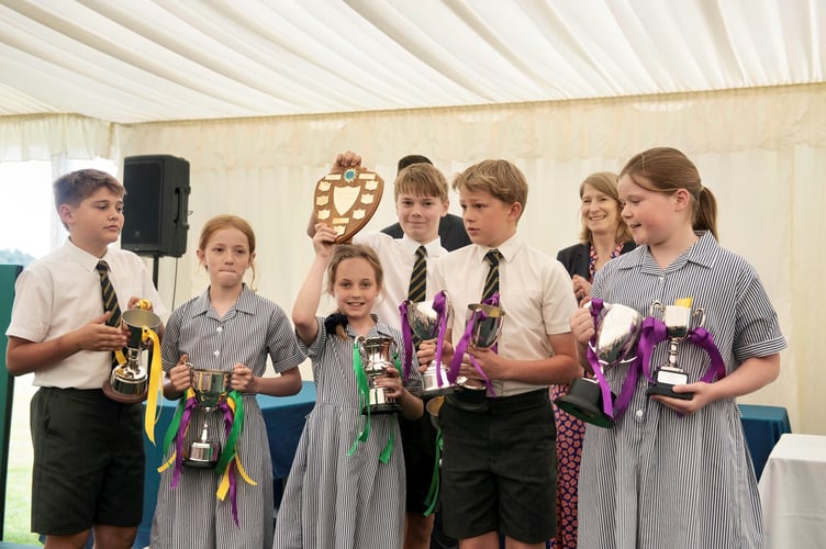 Prep school pupils with the winning house cups