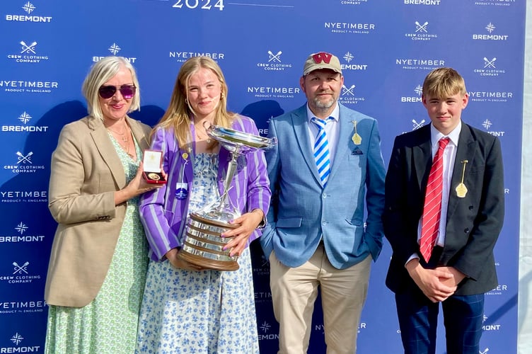 Monmouth's Violet Holbrow-Brooksbank holds the cup alongside her family