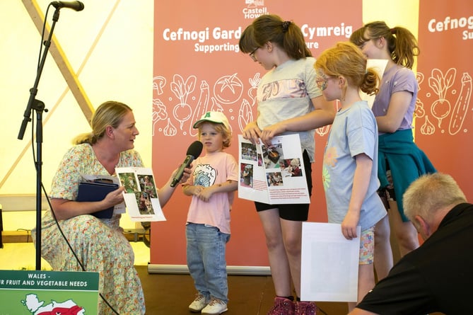 Royal Welsh Cross Ash School Head Teacher and Children 