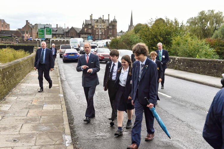 Prince head back to the helicopter with some of the school's sustainability students