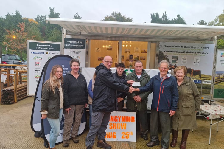 The six  members of the Show Committee at the Livestock Market, showing Brian Cope (Chairman) presenting a cheque to Bob Stevenson (MRSC Project Lead)