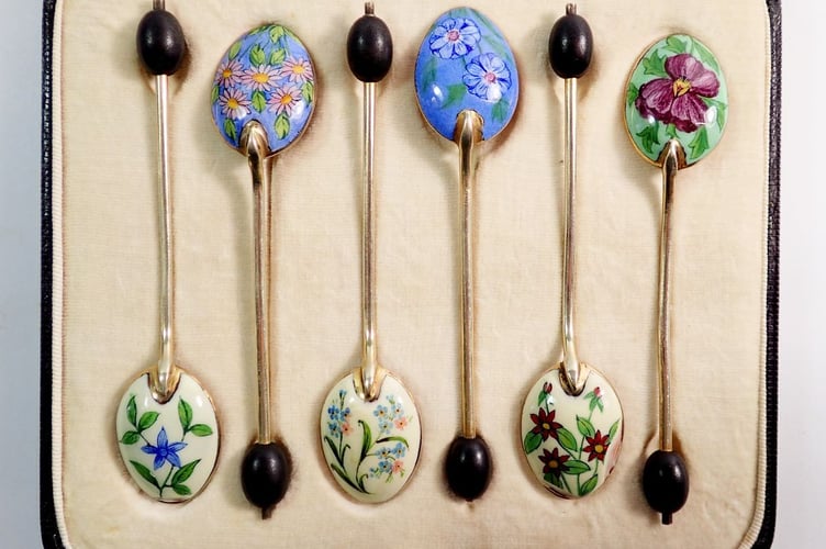 A set of silver and enamel teaspoons