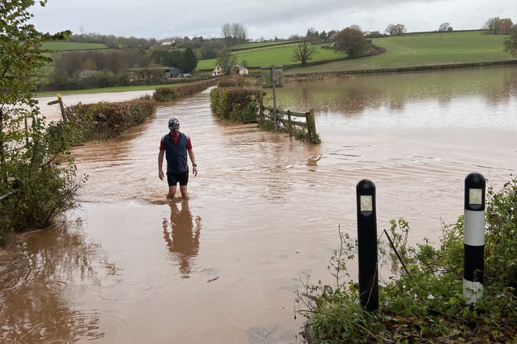 An intrepid runner waded through the flooded road off Tregate Bridge