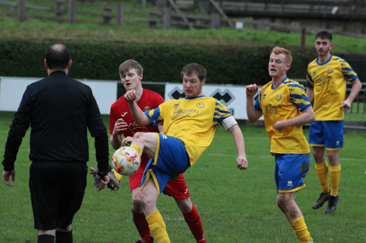 A Monmouth player gets to the ball first