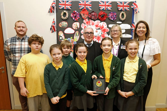 Children at the school proudly show off their Armed Forces Friendly Schools Award