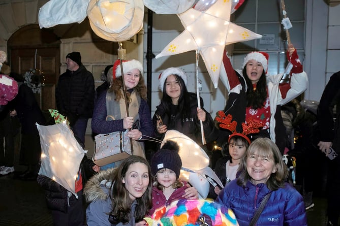 A parade of lanterns stops in the square