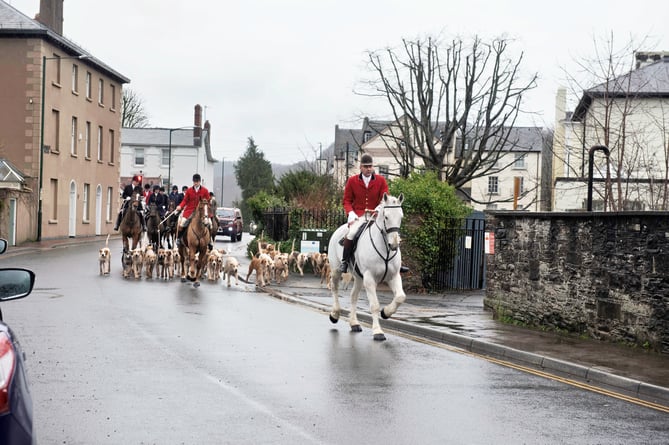 Horses and hounds make their way along Priory Street for the annual meet