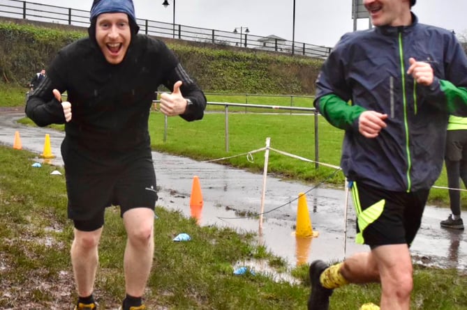 A runner gives the thumbs up at the finish of the Chippenham Fields New Year's Day parkrun