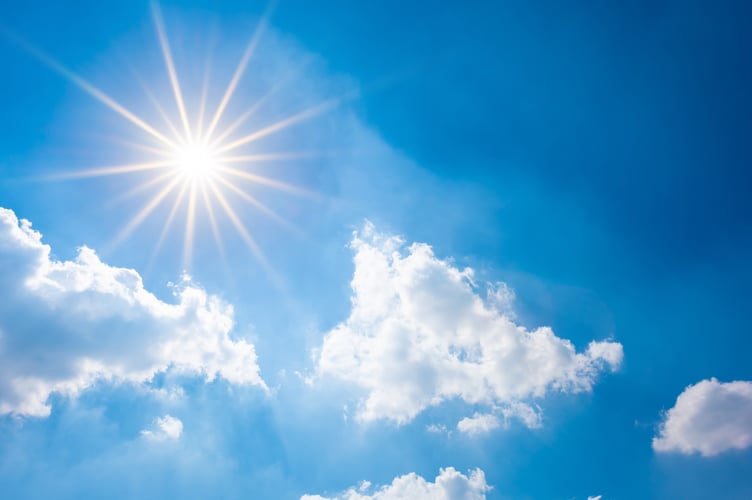 Sunny background, blue sky with white clouds and sun