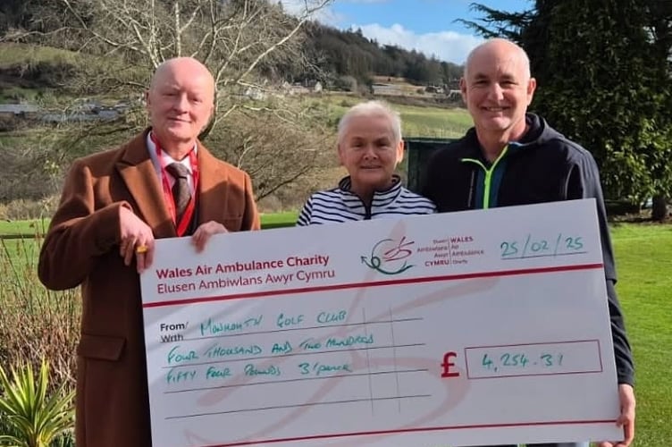 The cheque being presented by Jon Davies, MGC Captain, and Mary Woolard MBE, MGC Ladies Captain, to Rob Evans of Wales Air Ambulance